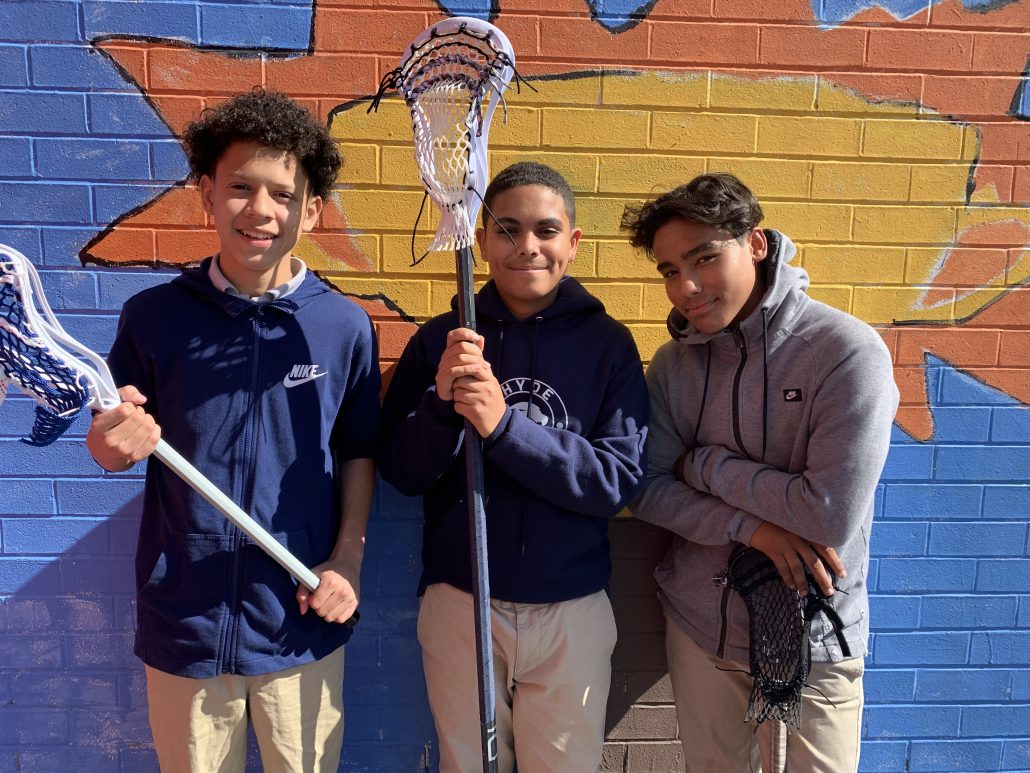 Enmanuel Hernandez (middle) and his teammates Eric Rosario Jr. (left) and Edgar Garcia (right) take a break from practicing their skills at recess. 
